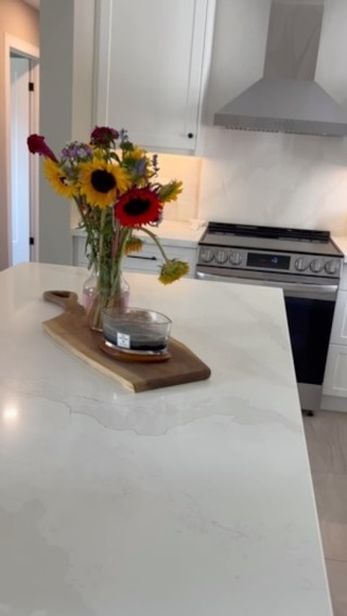 Spotless white kitchen with fresh flowers